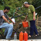 Migdalia Aceuedo and her son Mathews Rosado Aceuedo collect spring water for their house in Utuado, Puerto Rico, on Oct. 10, 2017, by a downed power line nearly three weeks after Hurricane Maria hit the island. (Mario Tama/Getty Images)